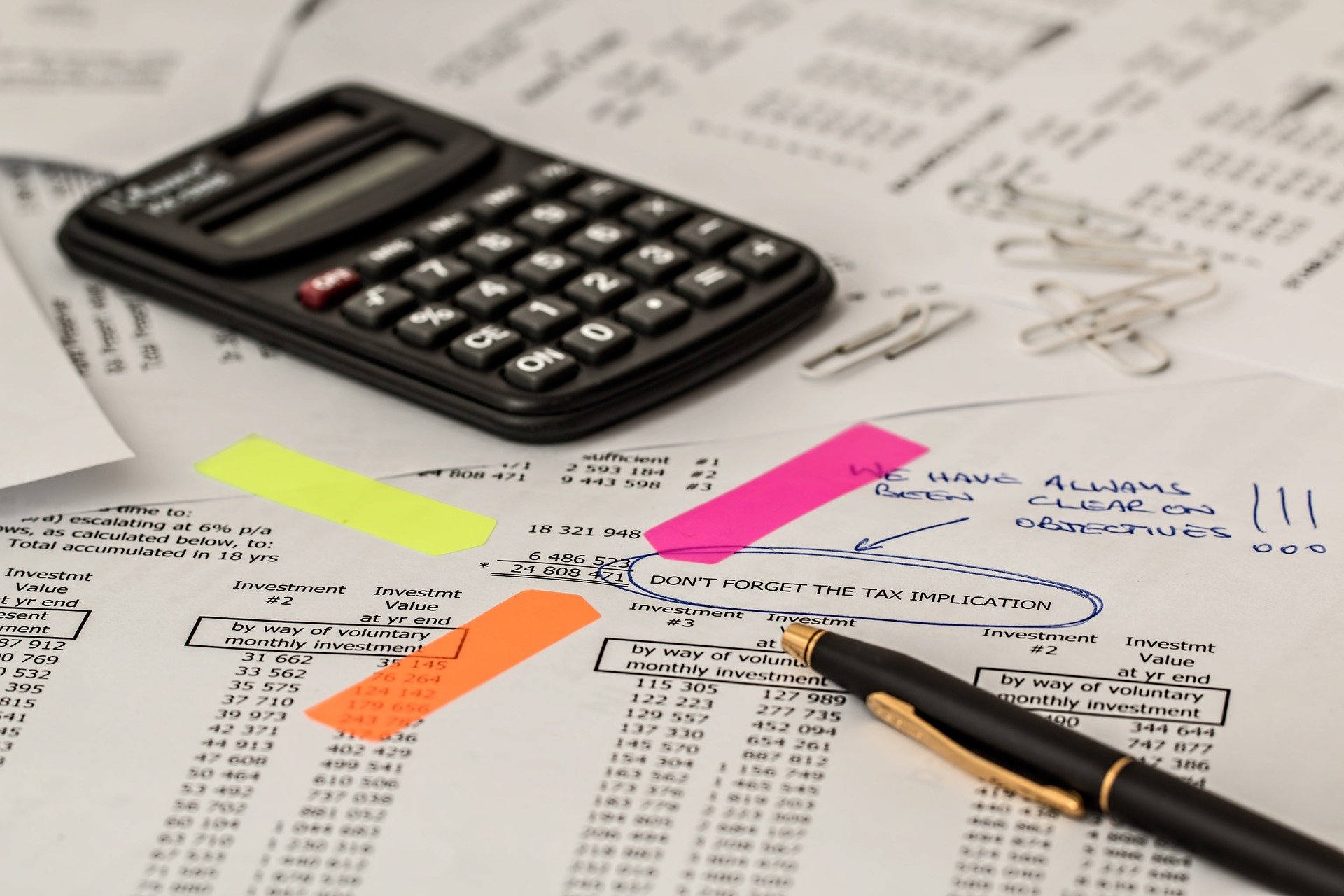 calculator and a pen on tax paperwork